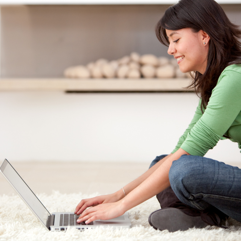 Lady sat on the floor at her computer