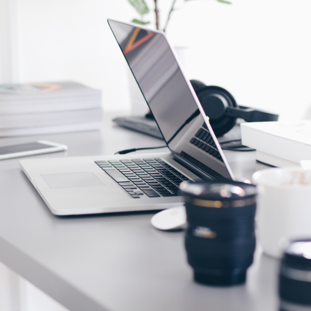 desk with laptop and other items on it