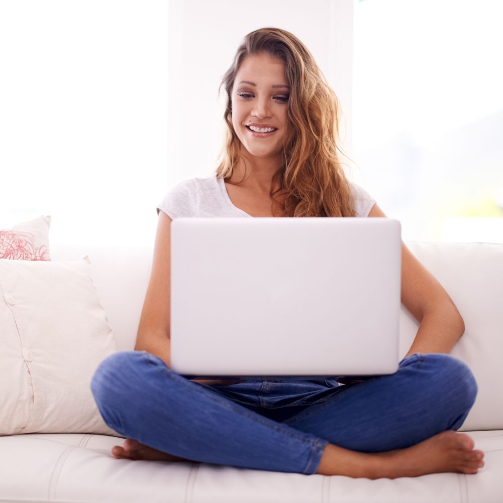 person sat on a sofa blogging
